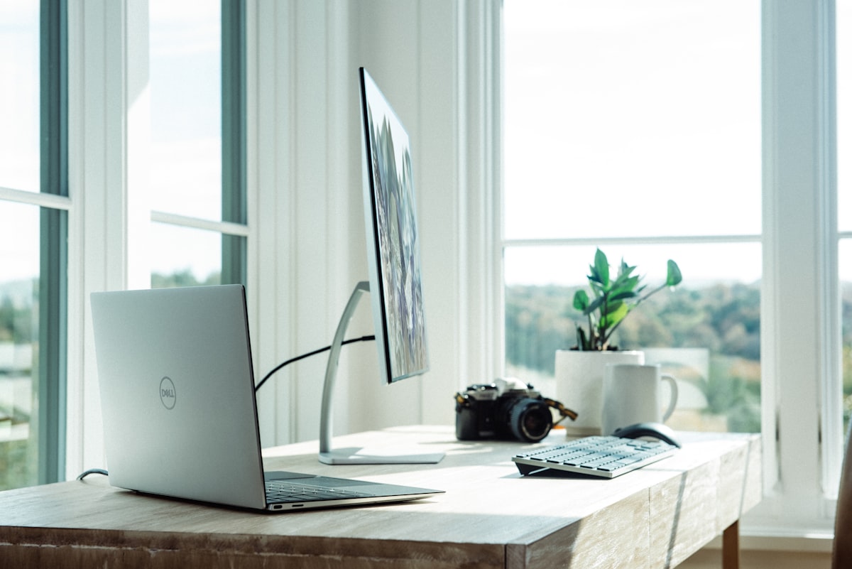 Business laptop and external monitor on an office desk